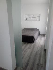 a small bedroom with a bed in a room at Jazmines in Santiago de la Ribera