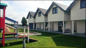 a row of houses with a playground at SEA & LAKE in Jarosławiec
