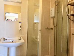 a bathroom with a sink and a shower at The Northdale Hotel Ltd in Skegness