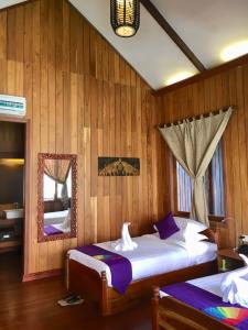 Postel nebo postele na pokoji v ubytování Inle Cottage Boutique Hotel