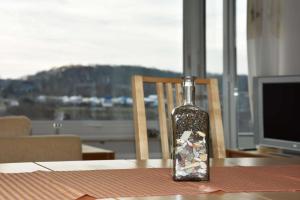 a bottle with rocks in it sitting on a table at Freiwasser Appartment in Glücksburg