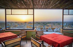 a room with two tables and a view of a city at 1st Gate Home- Fusion in Jaisalmer