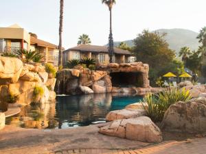 マルデールスドリフトにあるGlenburn Lodge & Spaの岩と家のある水たまり