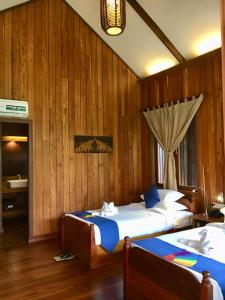 Postel nebo postele na pokoji v ubytování Inle Cottage Boutique Hotel