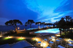 a view of a pool at night at Hotel Corte Valier in Lazise