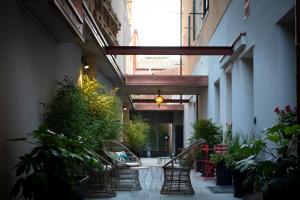 a hallway with chairs and plants in a building at Aqua Apartments in Venice