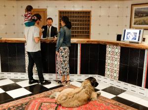 a group of people and a dog sitting on a floor at Hotel & SPA Llop Gris in El Tarter +104 photos