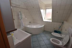 uma casa de banho com uma banheira, um WC e um lavatório. em Apartment Stuttgart Südheim em Stuttgart
