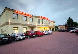un estacionamiento con coches estacionados frente a un hotel en Restauracja Hotel Przystan, en Lublin