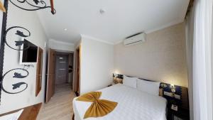 Postel nebo postele na pokoji v ubytování Patron Hotel