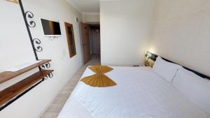 Postel nebo postele na pokoji v ubytování Patron Hotel