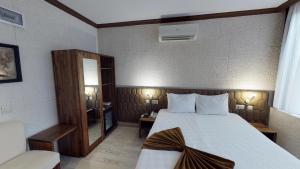 Postel nebo postele na pokoji v ubytování Patron Hotel