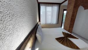 Postel nebo postele na pokoji v ubytování Patron Hotel