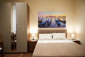 a bedroom with a bed with a painting on the wall at Miramare Luxury Suites in Trieste +35 photos
