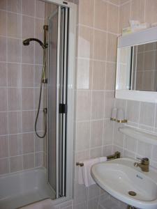 a bathroom with a shower and a sink at Villa Marina Wangerooge in Wangerooge