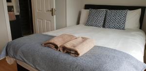 a bed with two towels sitting on top of it at Galway City Centre Apartment, Augustine Street in Galway +7 photos