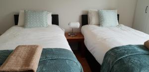 two beds sitting next to each other in a room at Galway City Centre Apartment, Augustine Street in Galway
