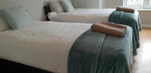 a bedroom with two beds with green and white at Galway City Centre Apartment, Augustine Street in Galway