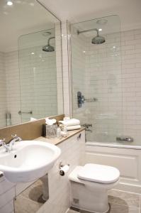 a bathroom with a sink, toilet and bathtub at The Bonham in Edinburgh