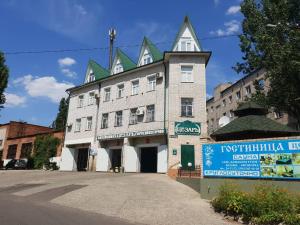 a large white building with a pointed roof at Ceasar in Mykolaiv