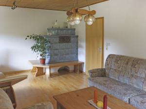 a living room with a couch and a table at Combined flat on a farm in Kellerwald in Bad Wildungen