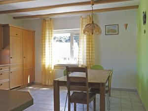 a kitchen with a table and chairs and a window at Wohnung in Huddingen mit Terrasse in Bad Wildungen