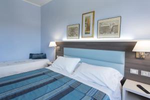 Posteľ alebo postele v izbe v ubytovaní Hotel Il Giardino + 34 fotografií