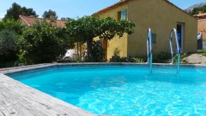 a swimming pool in front of a house at Sainte Victoire le Cabanon in Puyloubier