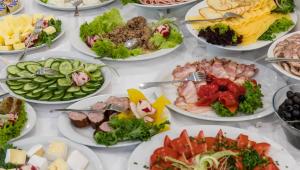 a table with many plates of food on it at Hotel Boruta in Zakopane