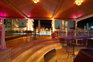 a restaurant with tables and chairs on a patio at Elena Hotel in Parga +45 photos