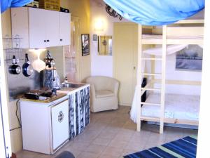 a kitchen with a sink and a bunk bed at Adonis Guesthouse in Batsi