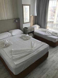 a bedroom with two beds and a window at Hotel Marine in Ayvalık +58 photos
