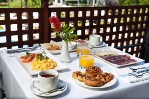 a table topped with plates of breakfast foods and drinks at Precise Resort El Rompido-The Hotel in El Rompido