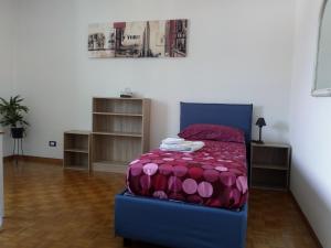 a bedroom with a bed with a purple comforter at B&B Taramelli - garage per bici o 2 moto in Trento