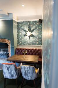a dining room with a table and a couch at The Dundas Arms in Kintbury