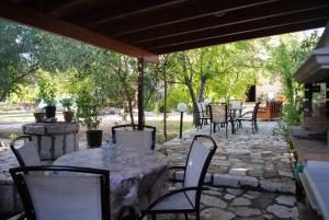 a table and chairs on a stone patio at Hotel Zefi in Syvota