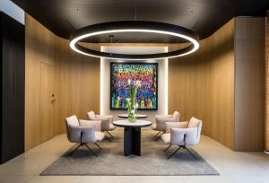 a lobby with a table and chairs and a painting at Mercure Paris 17 Batignolles in Paris