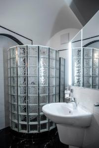 a white bathroom with a sink and a mirror at Villa am Park Apartment in Dresden