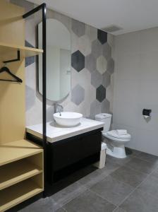a bathroom with a sink and a toilet at Nomaden Urban Stay in Semarang