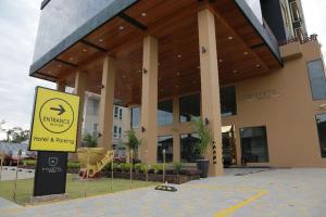a building with a yellow sign in front of it at Rivertel in Teluk Intan