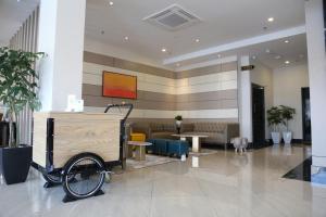 a lobby with a cart in the middle of a building at Rivertel in Teluk Intan