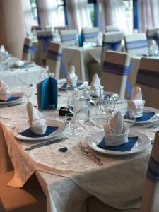a table with plates and wine glasses on it at Lido Hotel Residence in Cesenatico
