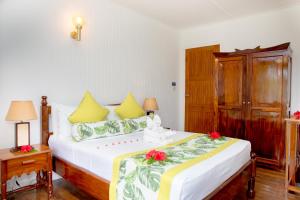 a bedroom with a large bed with flowers on it at La Digue Island Lodge in La Digue