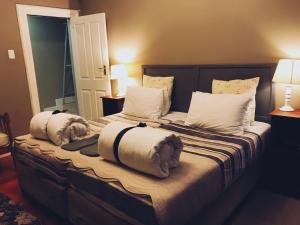 a bedroom with two beds with towels on them at 30 on Oatlands Road in Grahamstown