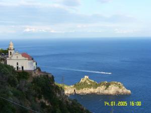 a castle on top of a hill in the ocean at Locanda Degli Agrumi in Conca dei Marini