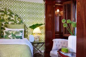 a bedroom with a bed and a table and a chair at Hotel Estheréa in Amsterdam