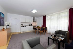 a living room with a couch and a table at Panoramablick Appartement - traumhaft! in Ober-Hambach