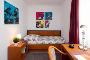 a small bedroom with a bed and a desk at Panoramablick Appartement - traumhaft! in Ober-Hambach