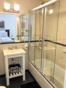 a bathroom with a glass shower and a sink at Petite Maison in Buenos Aires