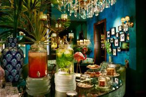 a room with a table with drinks and plates of food at Hotel Estheréa in Amsterdam